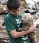 boy holds dog, pet rescues after oklahoma tornado