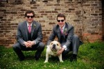 Dog poses with best men in wedding picture