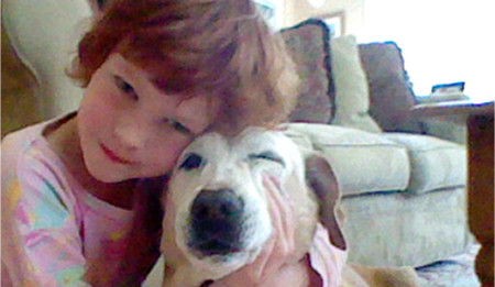 Catherine Violet Hubbard hugging her dog Sammy at their home in Newtown, CT. The 6-year-old was tragically killed on December 14, 2012 in the Sandy Hook Elementary School mass shooting./Photo credit:cvhfoundation.org